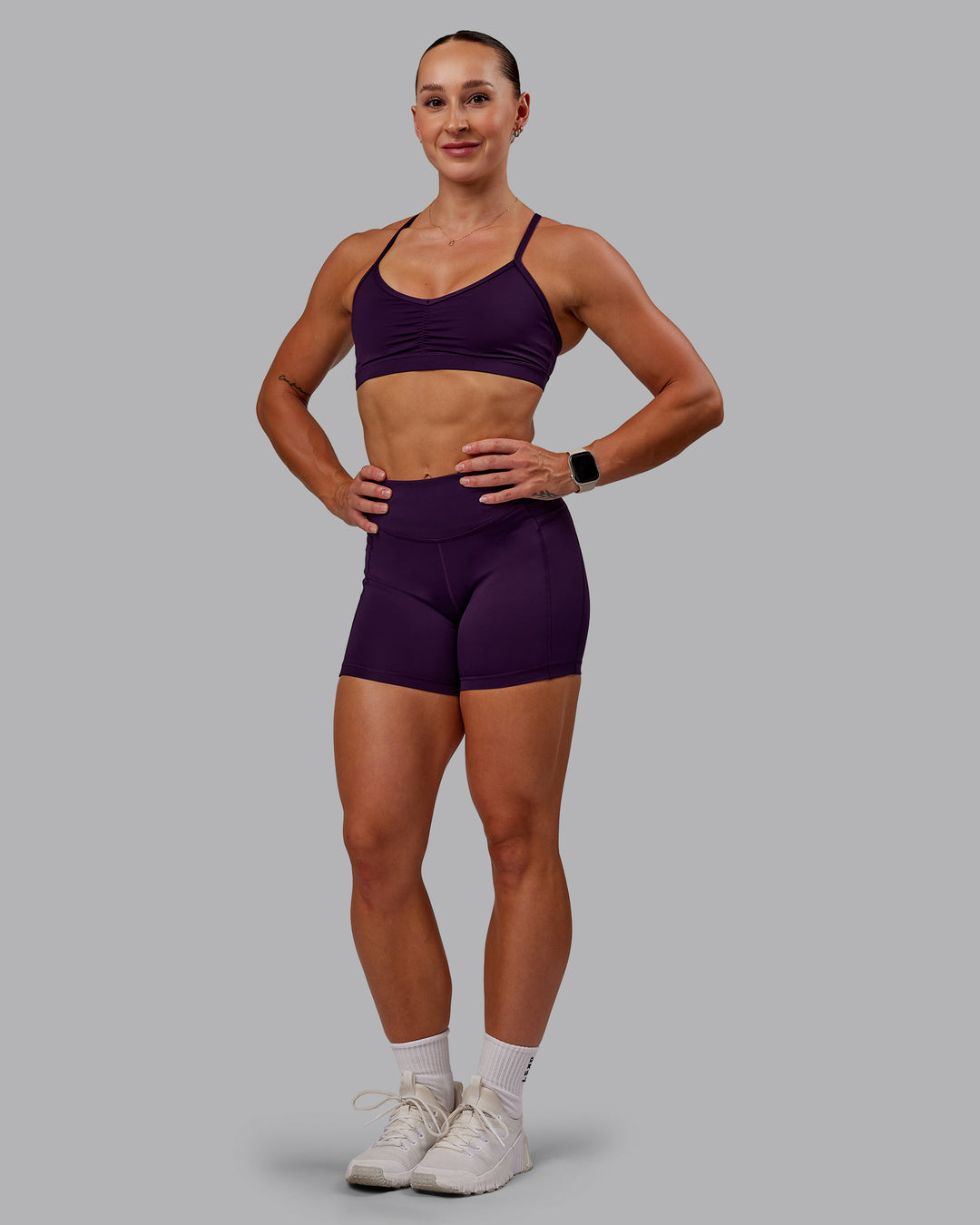 Woman wearing Clarity Sports Bra in Deep Purple | Size:S