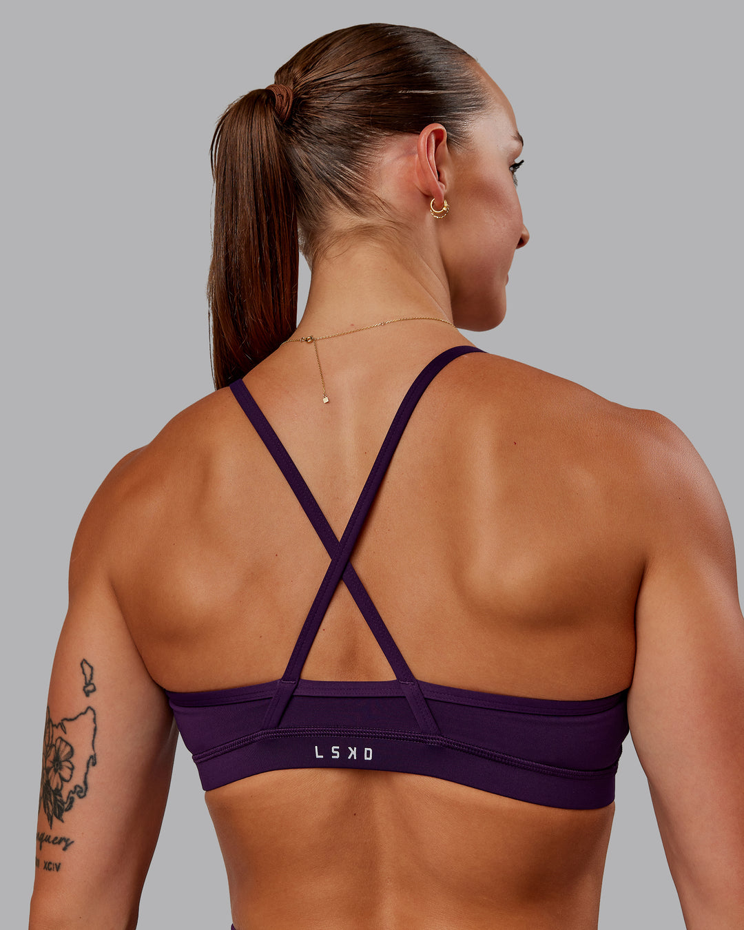 Woman wearing Clarity Sports Bra in Deep Purple | Size:S