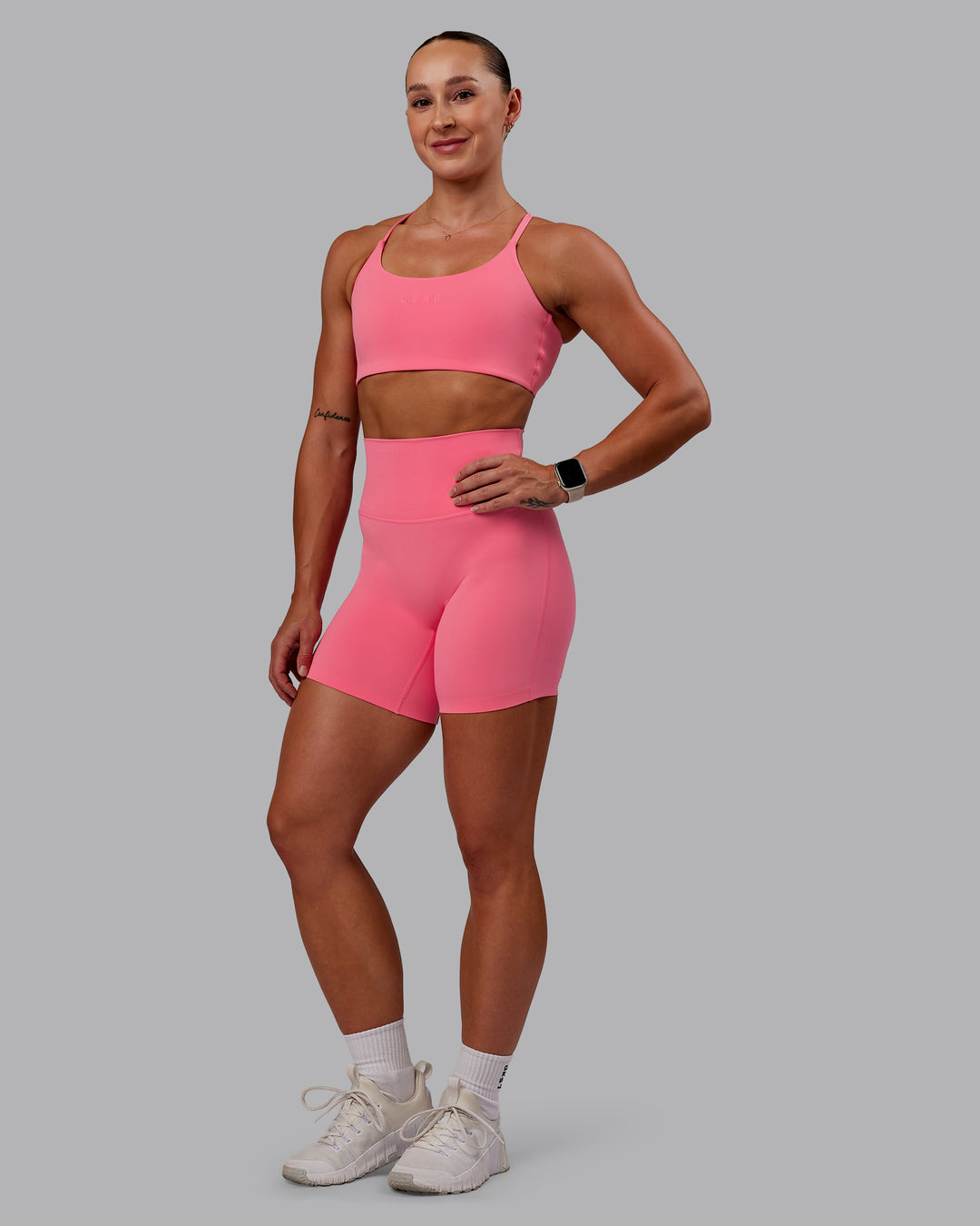 Woman wearing Elixir Mid Short Tight in Pink Lemonade | Size:S