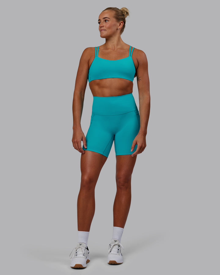 Woman wearing Elixir Mid Short Tights with Pockets - Blue Bird
