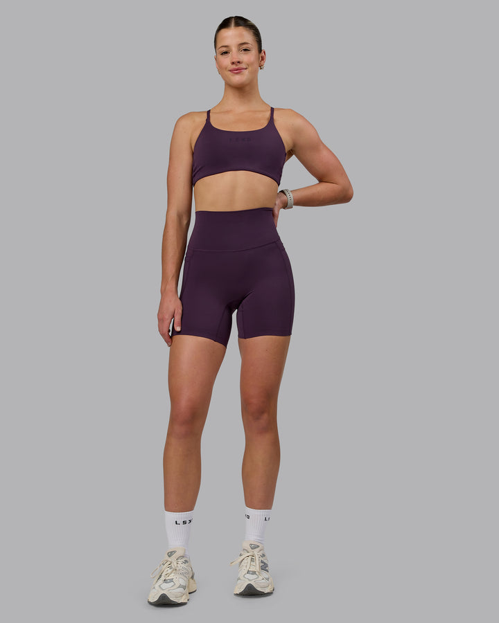 Woman wearing Elixir Mid Short Tights With Pockets - Midnight Plum
