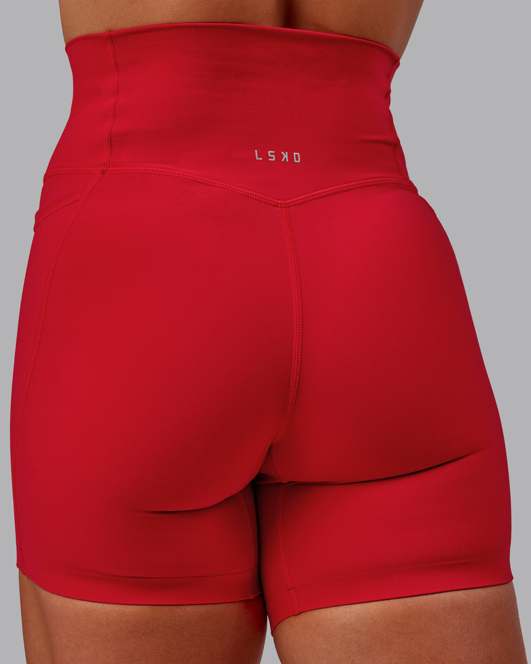 Woman wearing Elixir Mid Short Tight With Pockets in Flame | Size:S