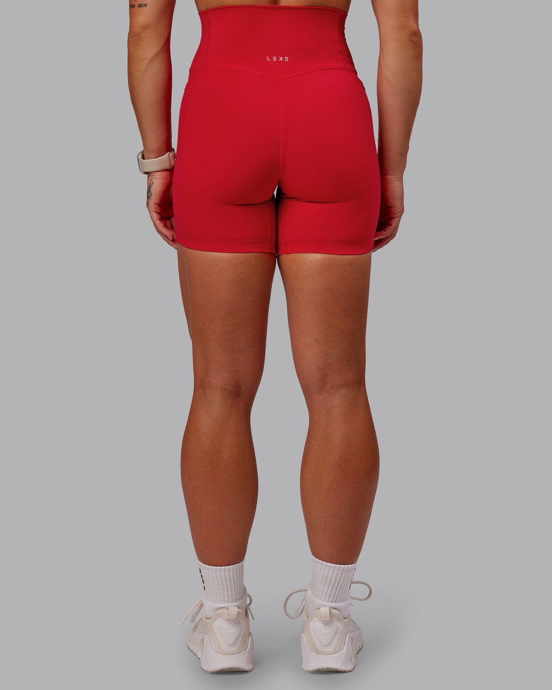 Woman wearing Elixir Mid Short Tight With Pockets in Flame | Size:S