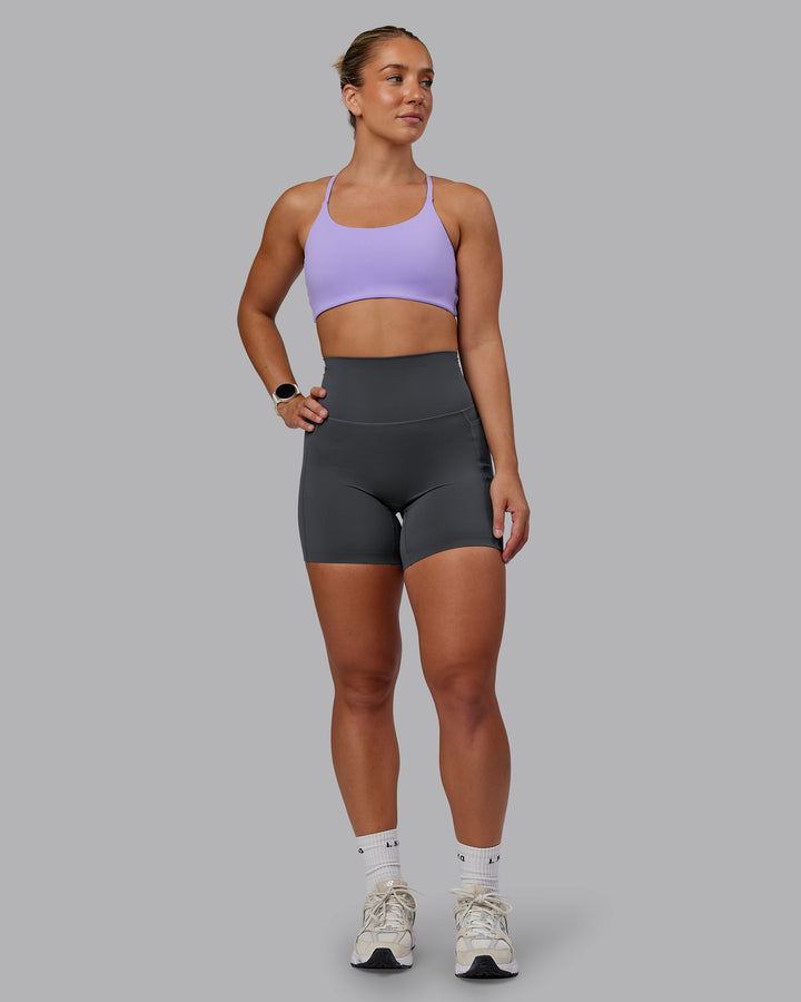 Woman wearing Elixir Mid Short Tight With Pockets in Dark Storm | Size:S
