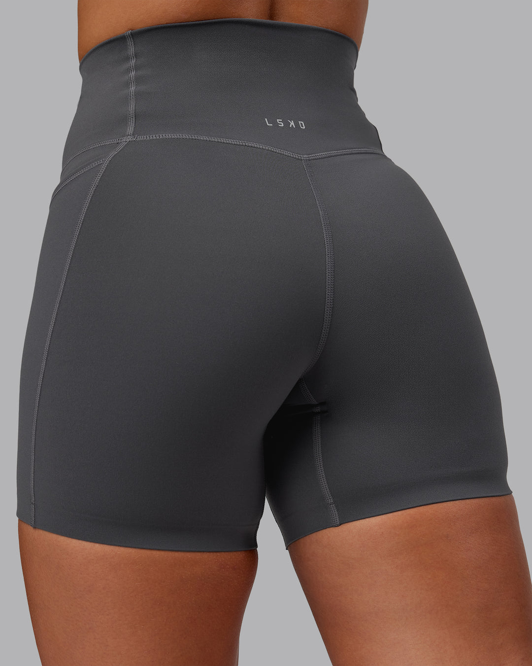 Woman wearing Elixir Mid Short Tight With Pockets in Dark Storm | Size:S