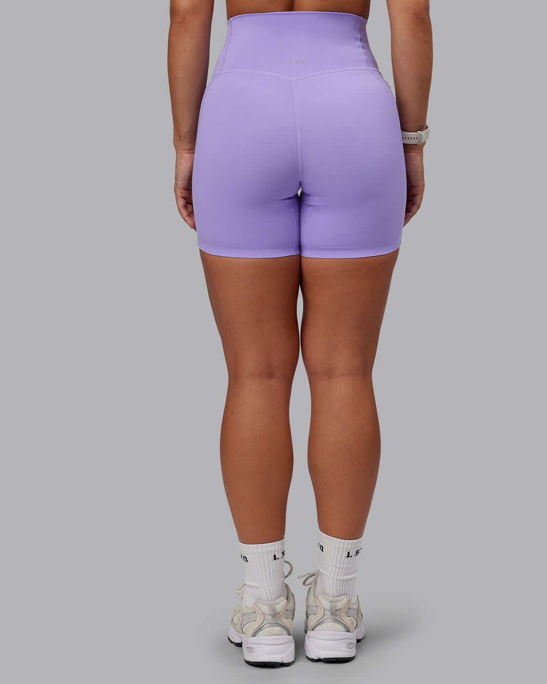 Woman wearing Elixir Mid Short Tight With Pockets in Violet Ray | Size:S