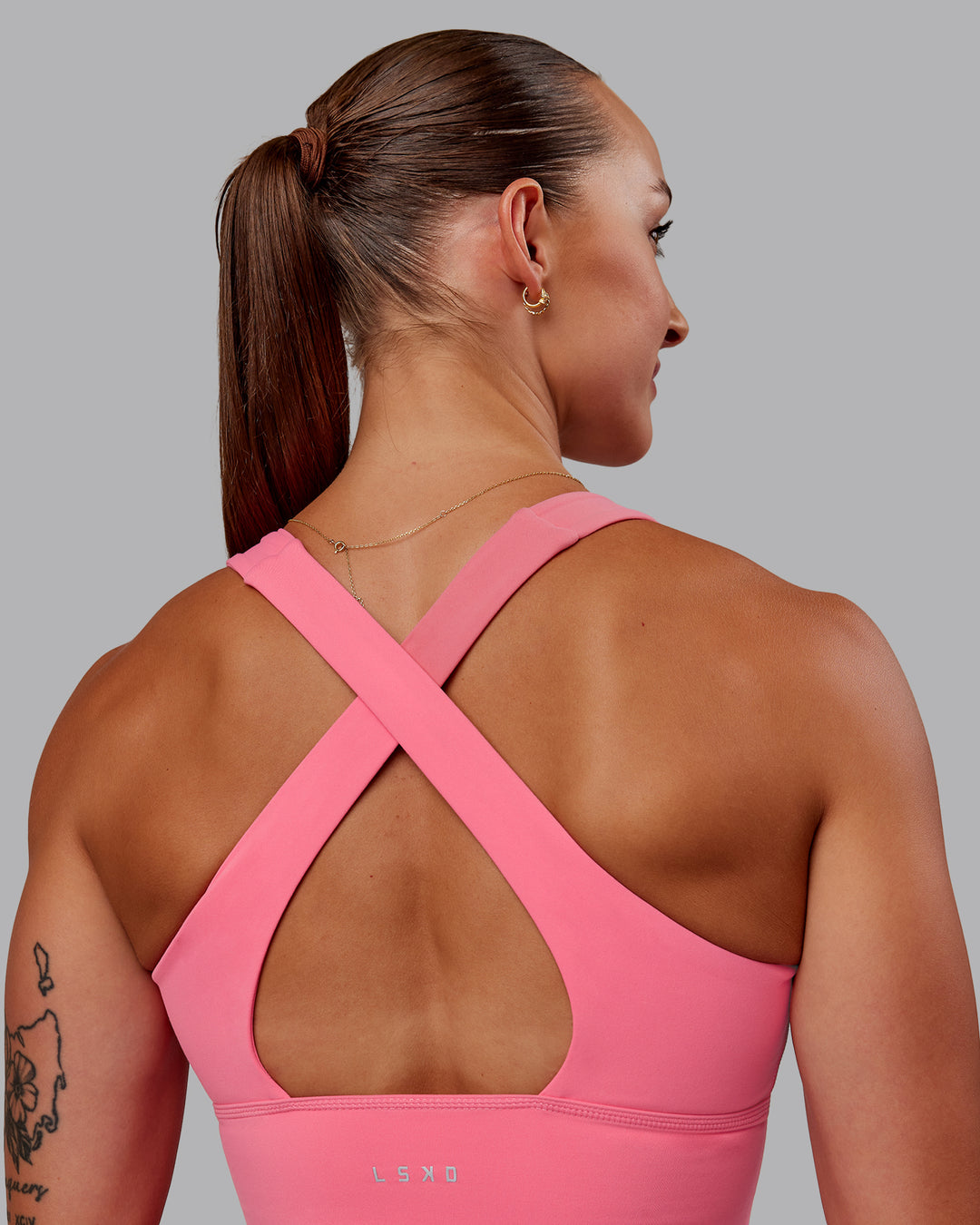 Woman wearing Evoke Sports Bra in Pink Lemonade | Size:S