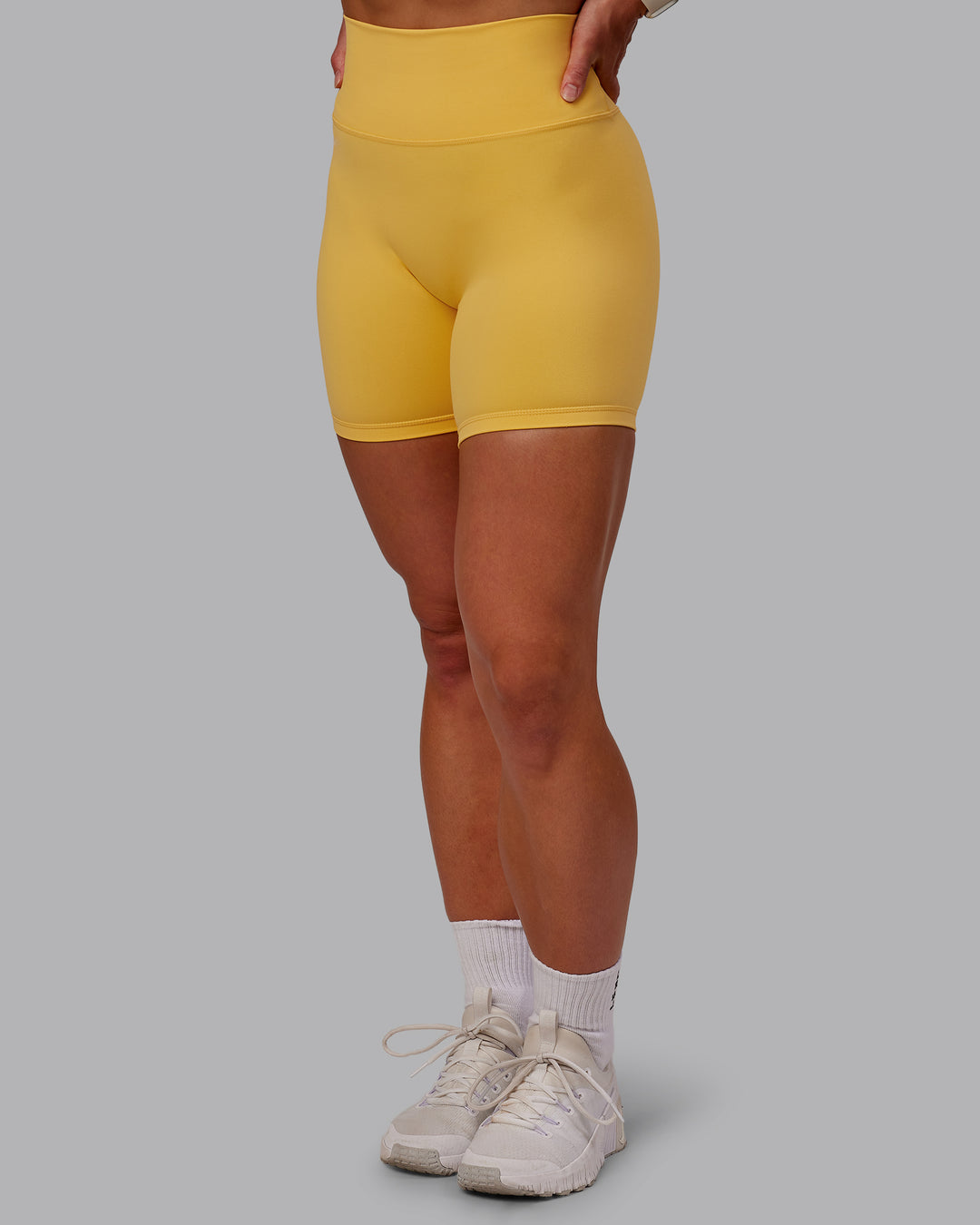 Woman wearing Fusion Mid Short Tight in Banana Cream | Size:S