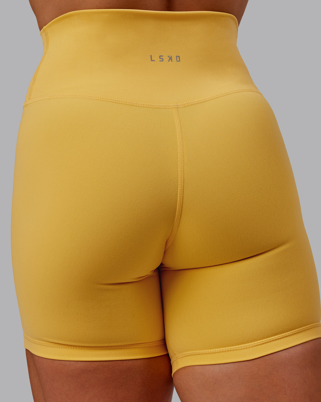 Woman wearing Fusion Mid Short Tight in Banana Cream | Size:S