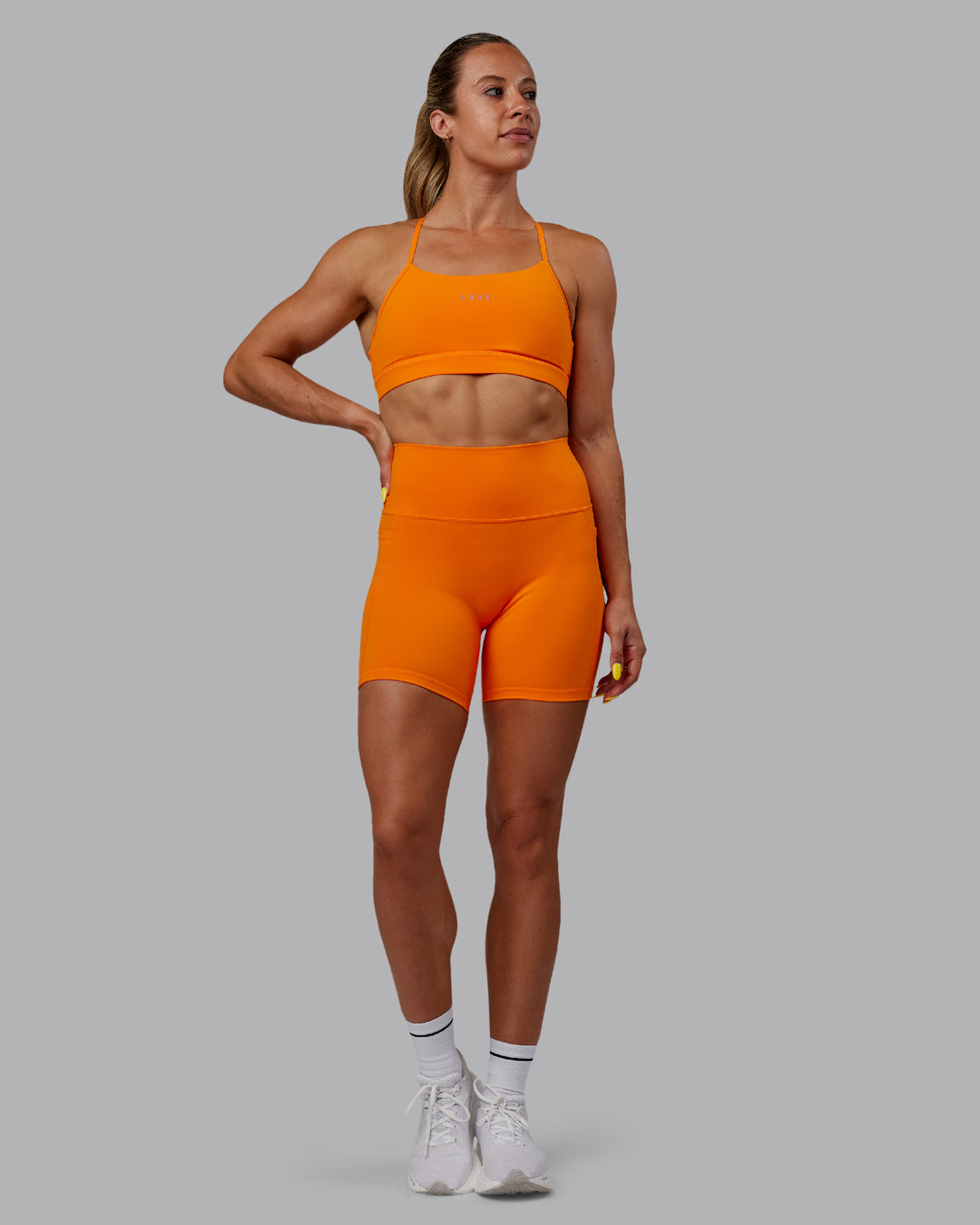 Woman wearing Fusion Mid Short Tights - Vibrant Orange