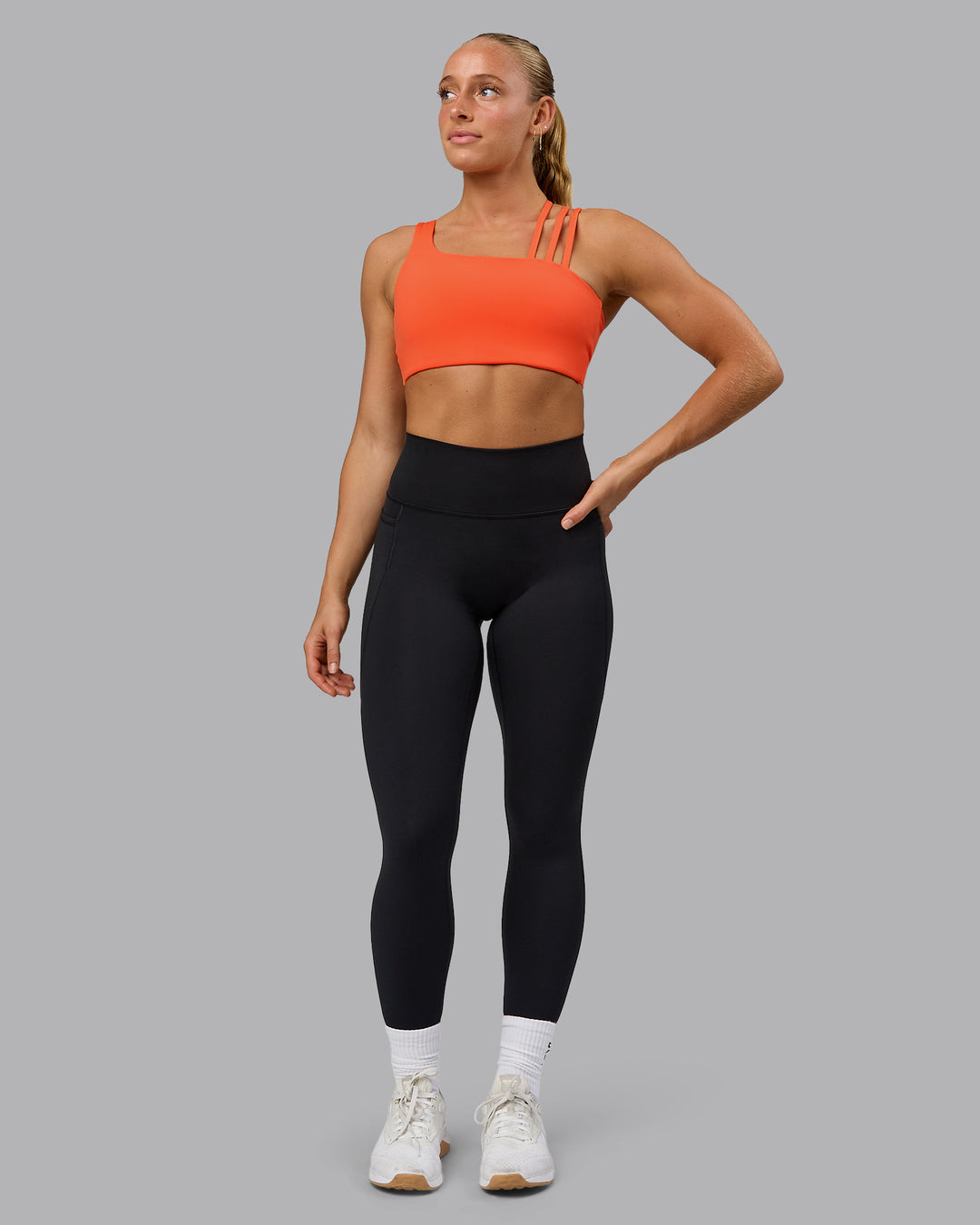 Woman wearing Galvanise Sports Bra - Ultra Orange