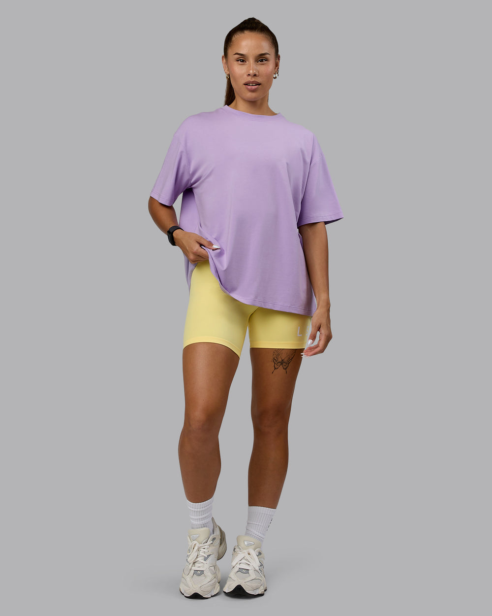 Woman wearing Go-To Set The Standard FLXCotton Oversized Tee - Pale Lilac-Elfin Yellow