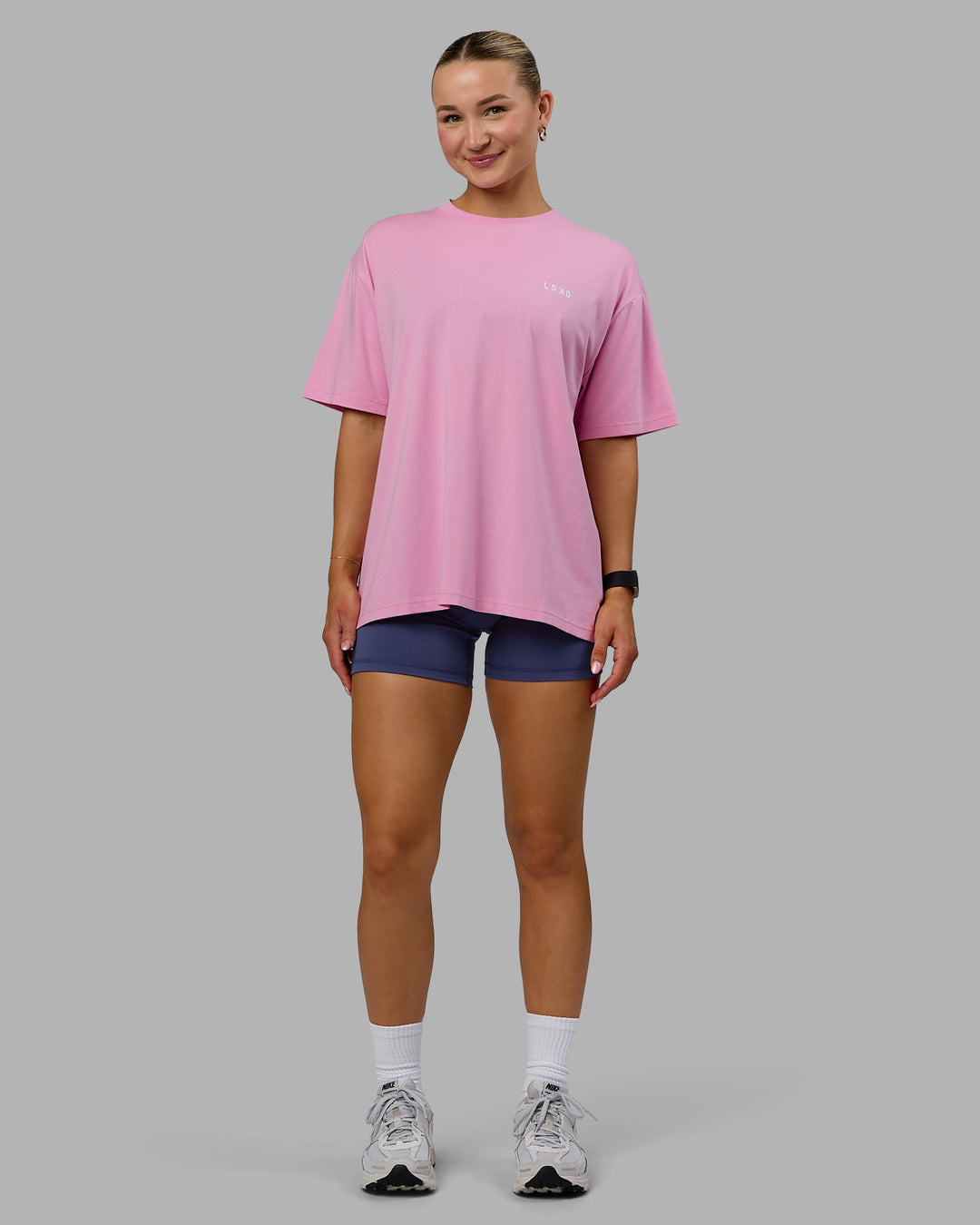 Woman wearing Go-To We Rise FLXCotton Oversized Tee - Bubblegum-White