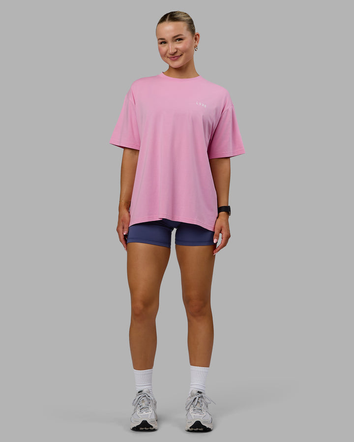 Woman wearing Go-To We Rise FLXCotton Oversized Tee - Bubblegum-White
