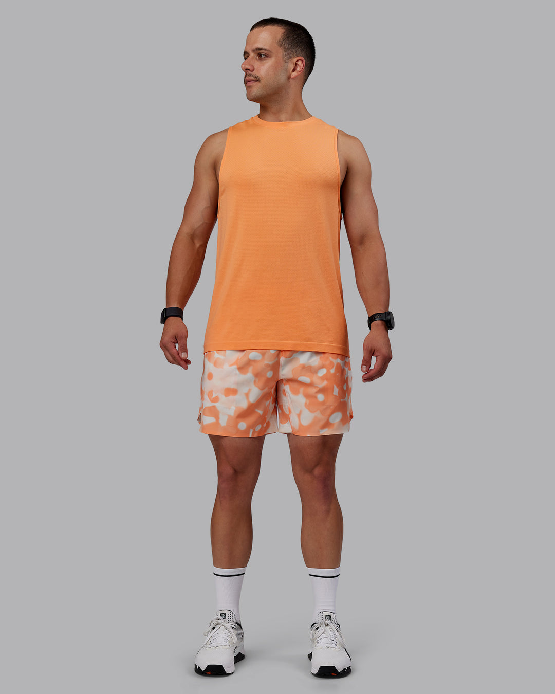 Man wearing Grand Slam 6&quot; Shorts in Wildflower Cantaloupe | Size:S