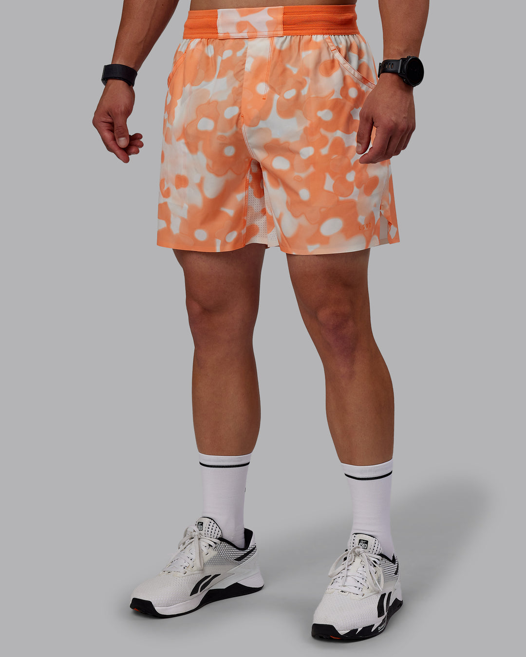  Man wearing Grand Slam 6&quot; Shorts in Wildflower Cantaloupe | Size:S