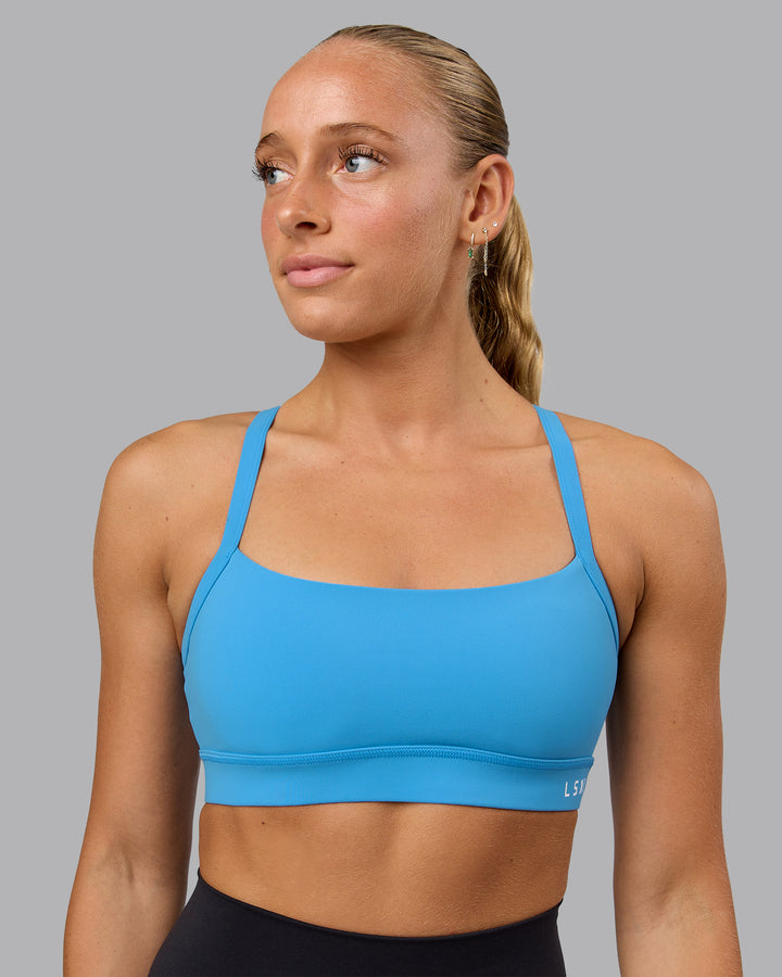 Woman wearing Momentum Sports Bra in Azure Blue | Size:S
