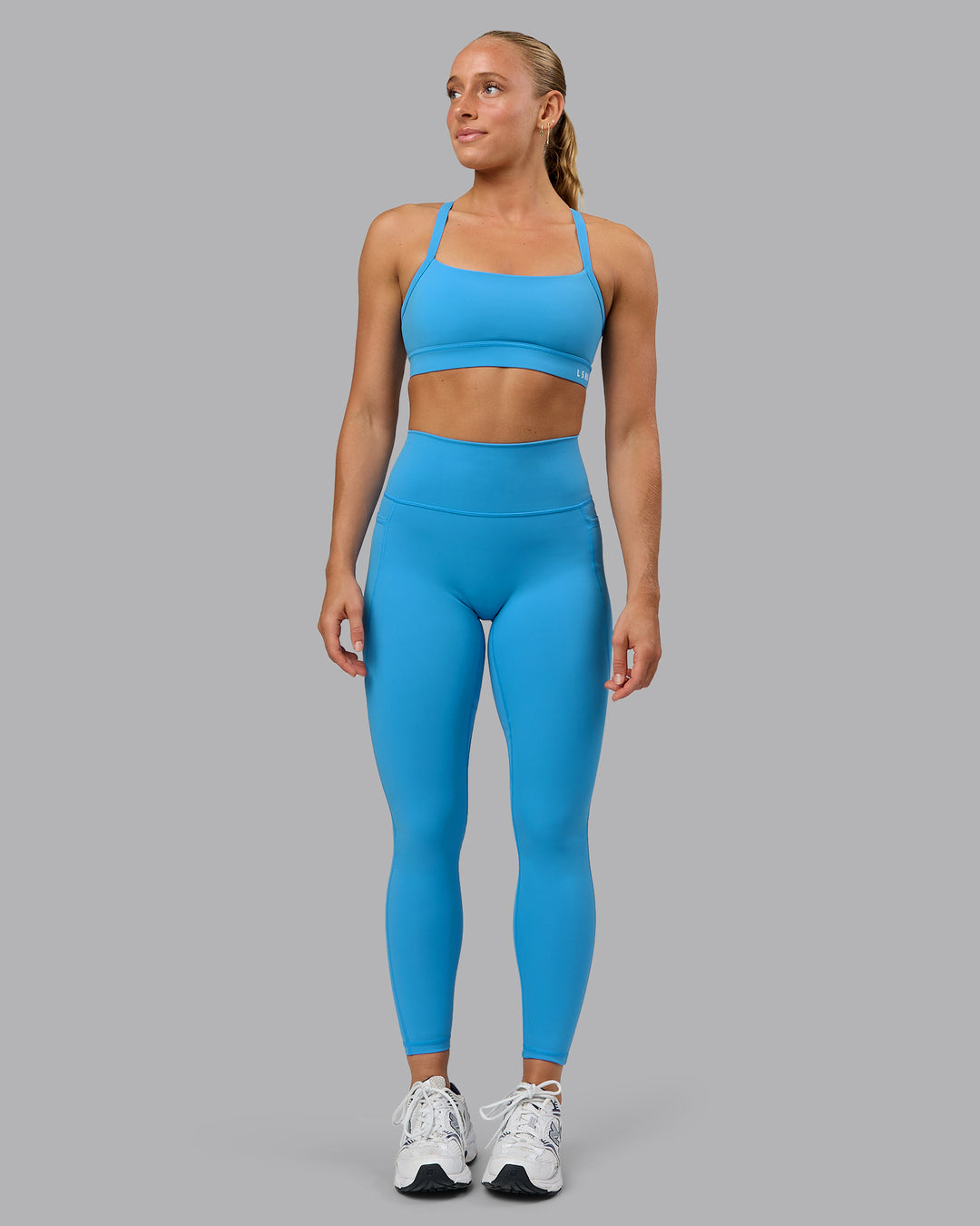 Woman wearing Momentum Sports Bra in Azure Blue | Size:S