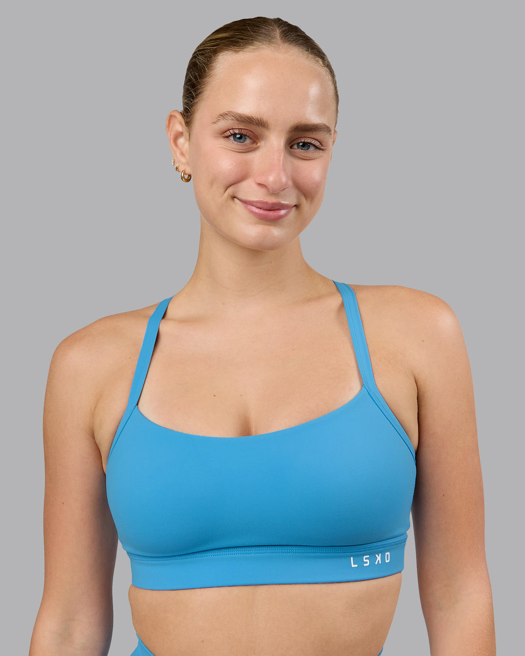 Woman wearing Momentum Sports Bra (D/DD/E) in Azure Blue | Size:S