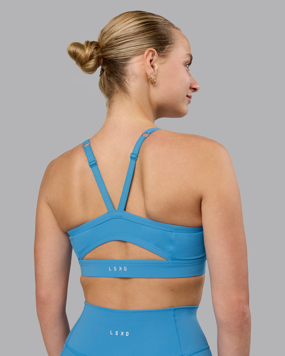 Woman wearing Momentum Sports Bra (D/DD/E) in Azure Blue | Size:S