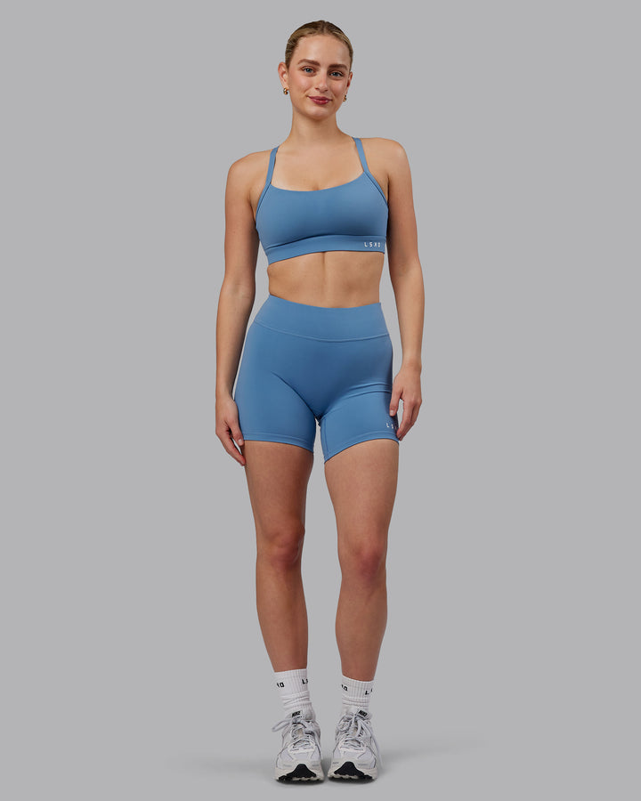 Woman wearing Momentum Sports Bra (D/DD/E) - Elemental Blue
