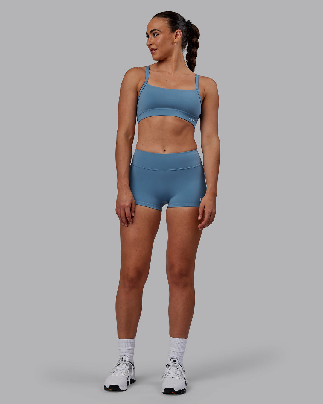 Woman wearing Momentum Sports Bra - Elemental Blue