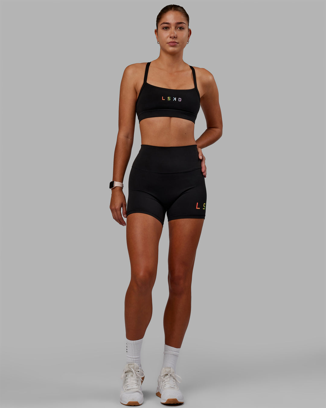 Woman wearing Momentum Sports Bra - Pride-Black