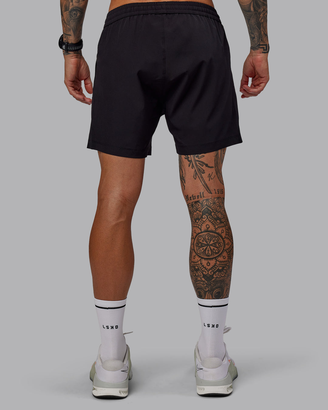 Man wearing Rep 5&quot; Lined Performance Shorts in Black | Size:S