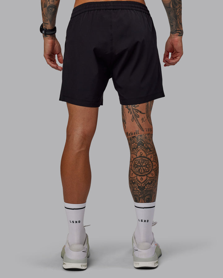 Man wearing Rep 5&quot; Lined Performance Shorts in Black | Size:S
