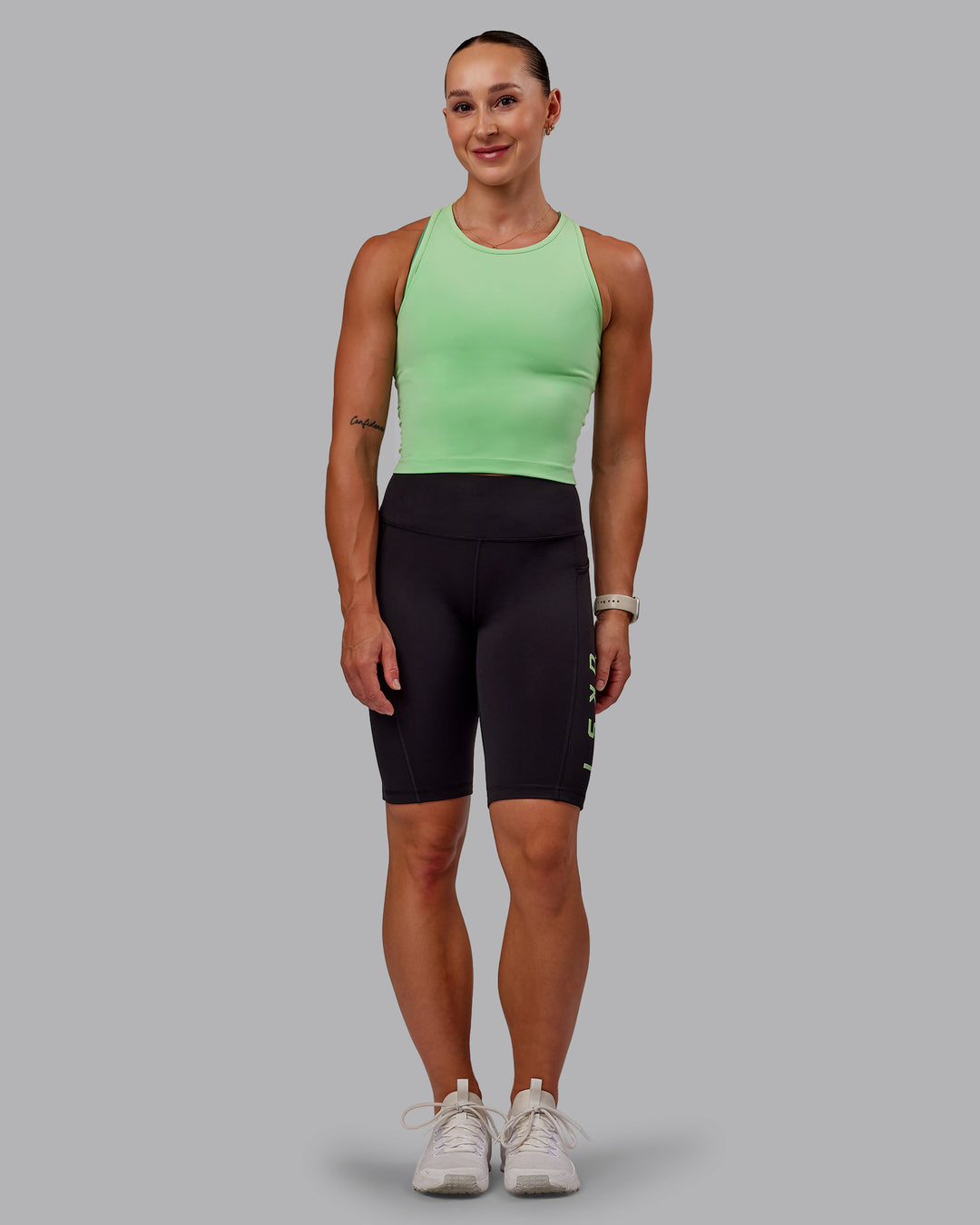 Woman wearing Rep Bike Shorts - Black-Surreal Green