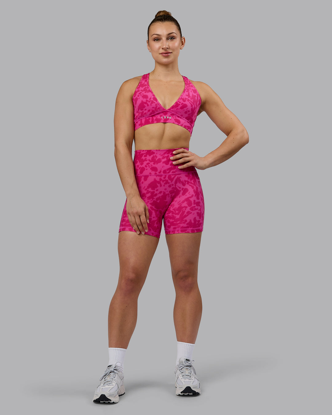 Woman wearing Stamina Sports Bra - Strawberry-Lava Lamp