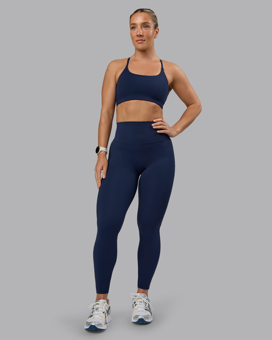 Woman wearing Twist Sports Bra - Future Navy