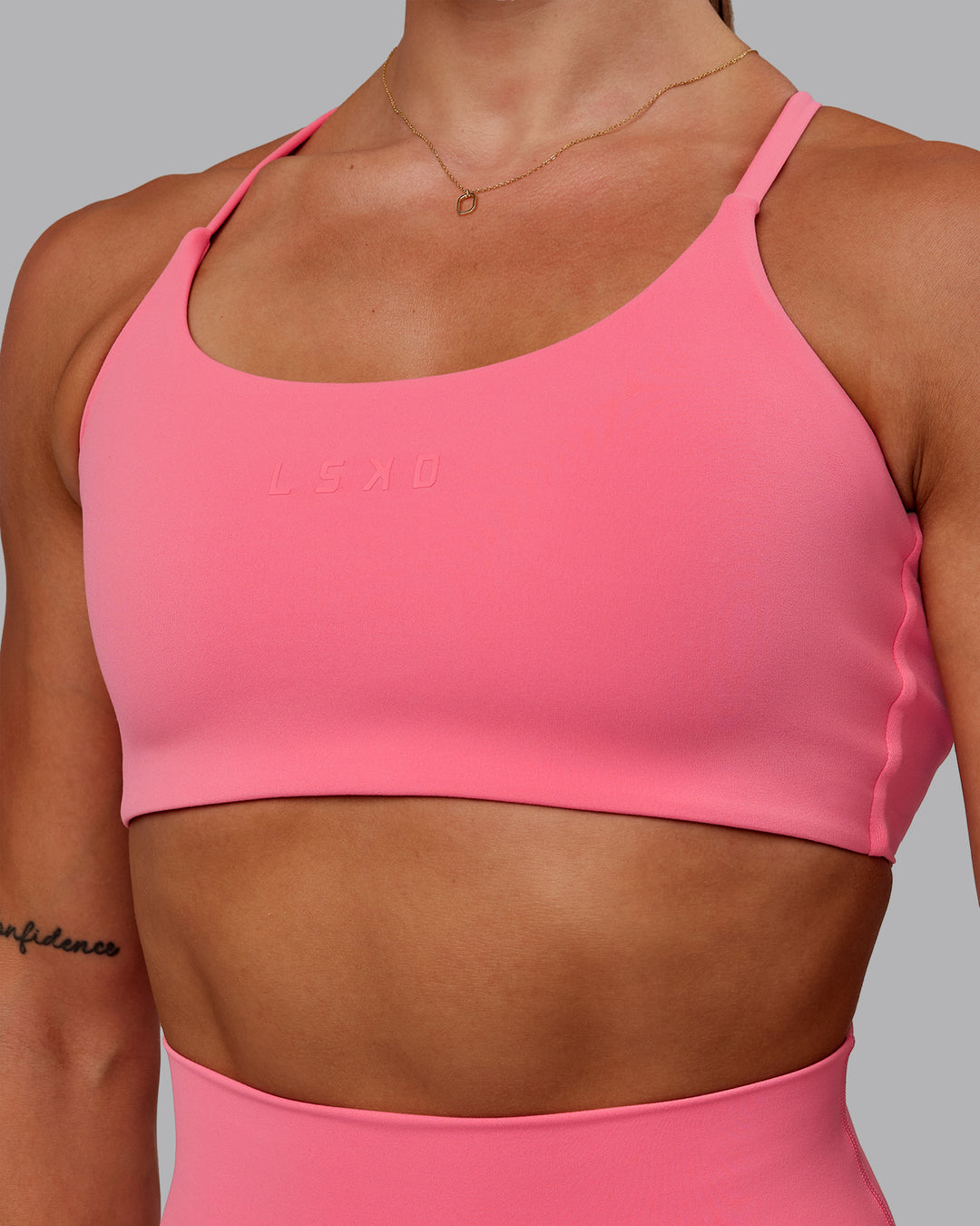 Woman wearing Twist Sports Bra in Pink Lemonade | Size:S