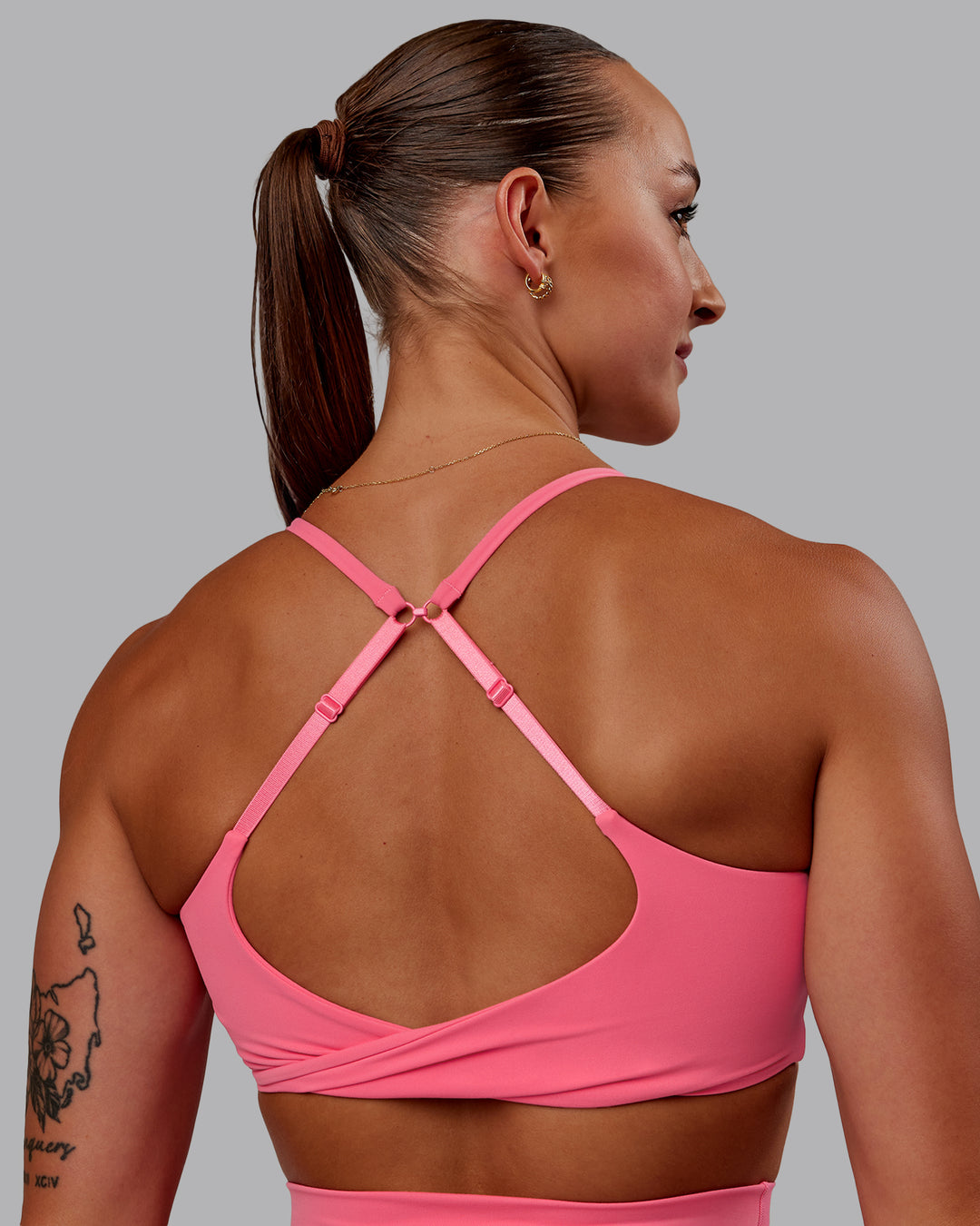 Woman wearing Twist Sports Bra in Pink Lemonade | Size:S