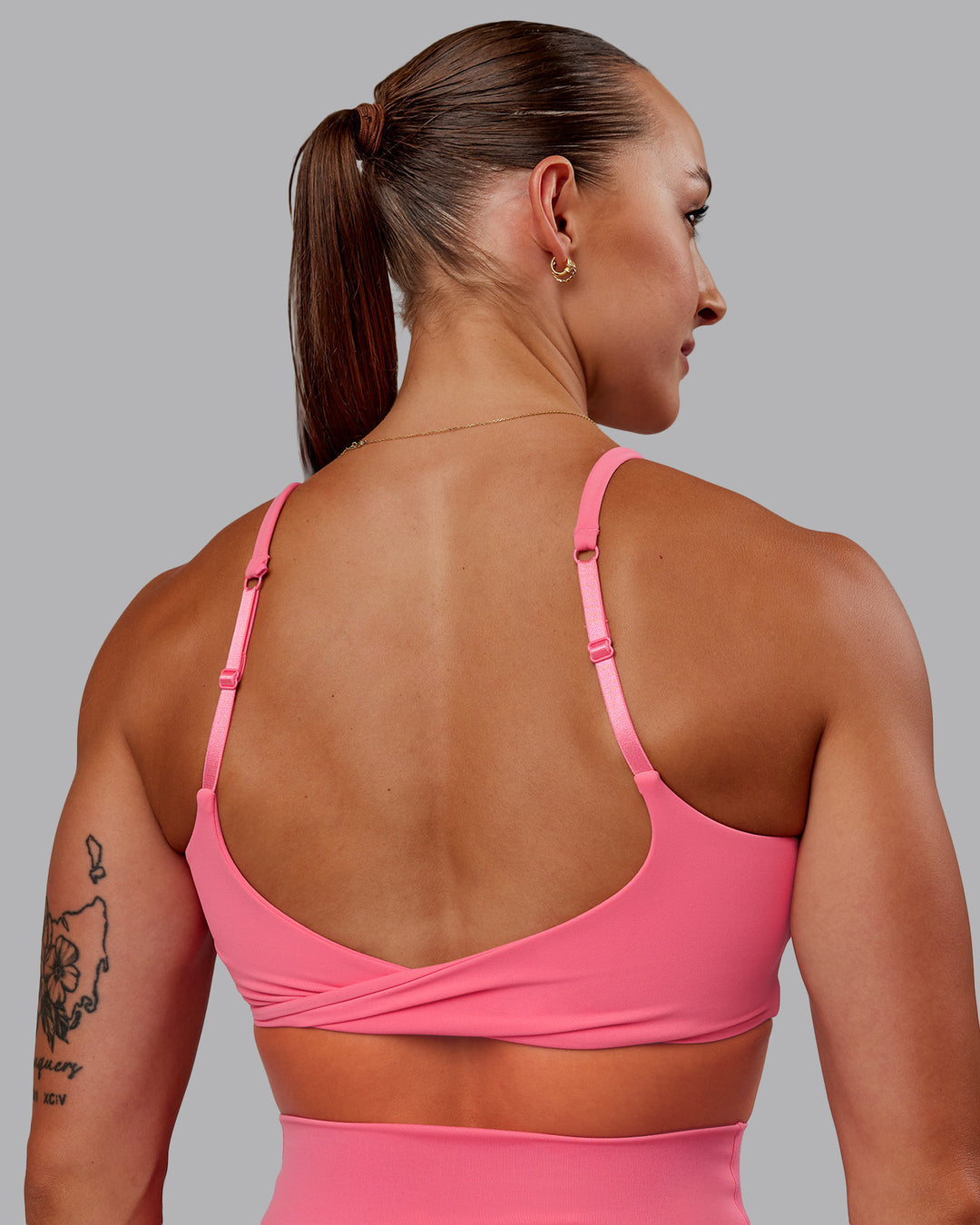 Woman wearing Twist Sports Bra in Pink Lemonade | Size:S