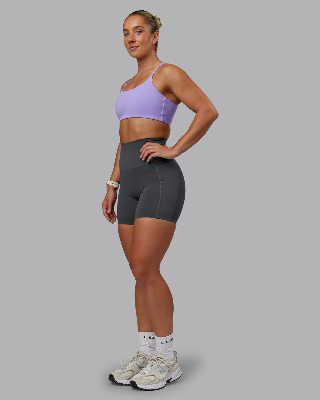 Woman wearing Twist Sports Bra in Violet Ray | Size:S