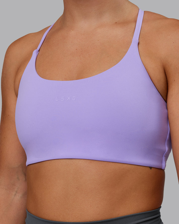 Woman wearing Twist Sports Bra in Violet Ray | Size:S
