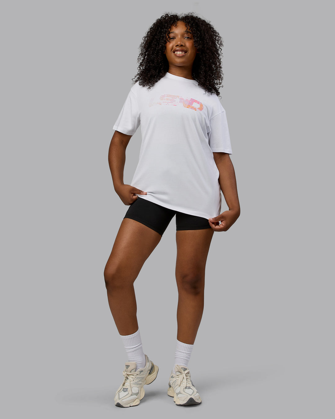 Woman wearing Unisex Motion FLXCotton Tee Oversize - White-React Print