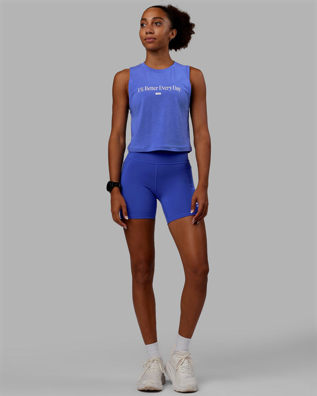 Woman wearing Vital 1% Better Cropped Training Tank - Power Cobalt Marl-White