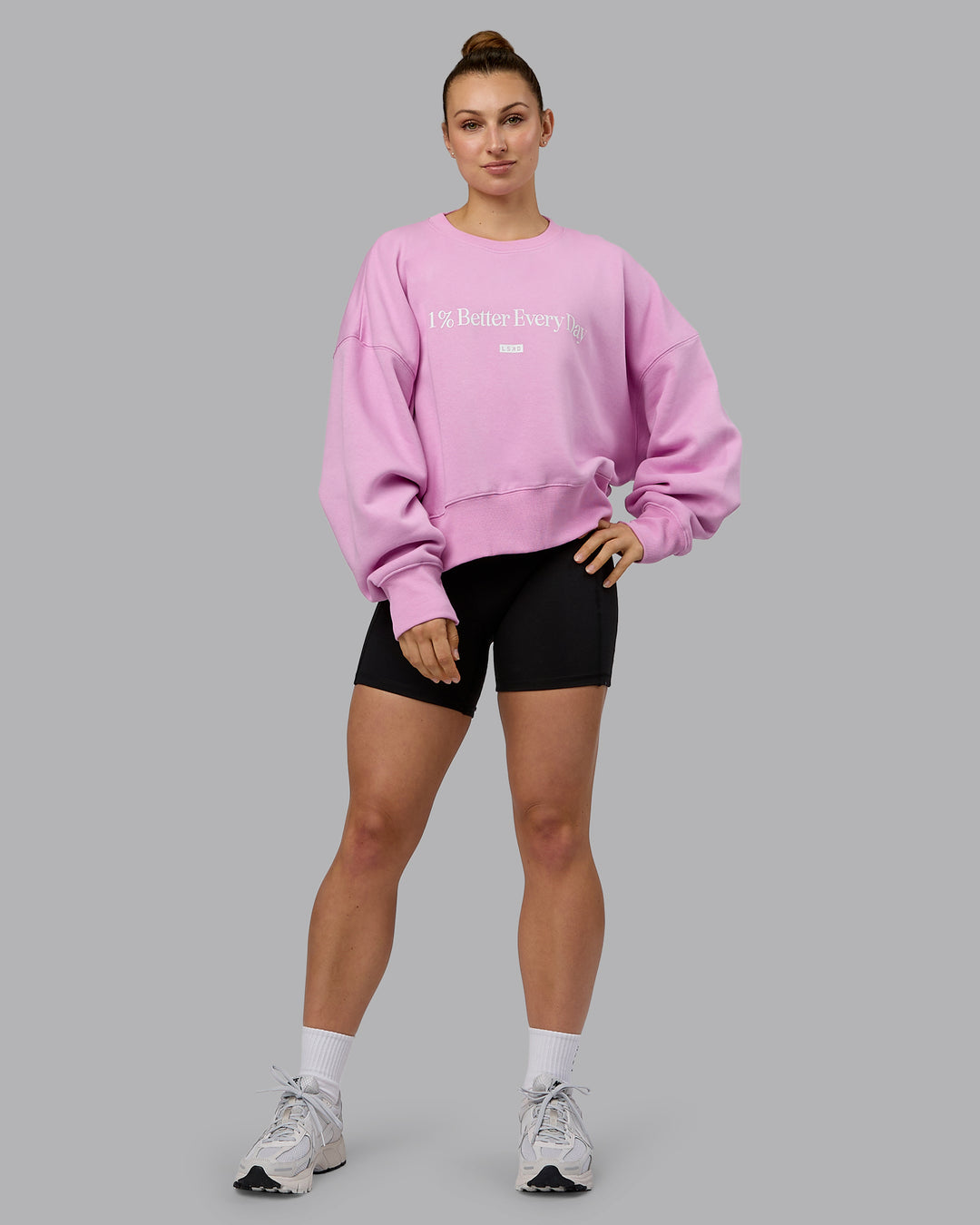 Woman wearing 1% Better Heavyweight Sweater - Pastel Orchid-White