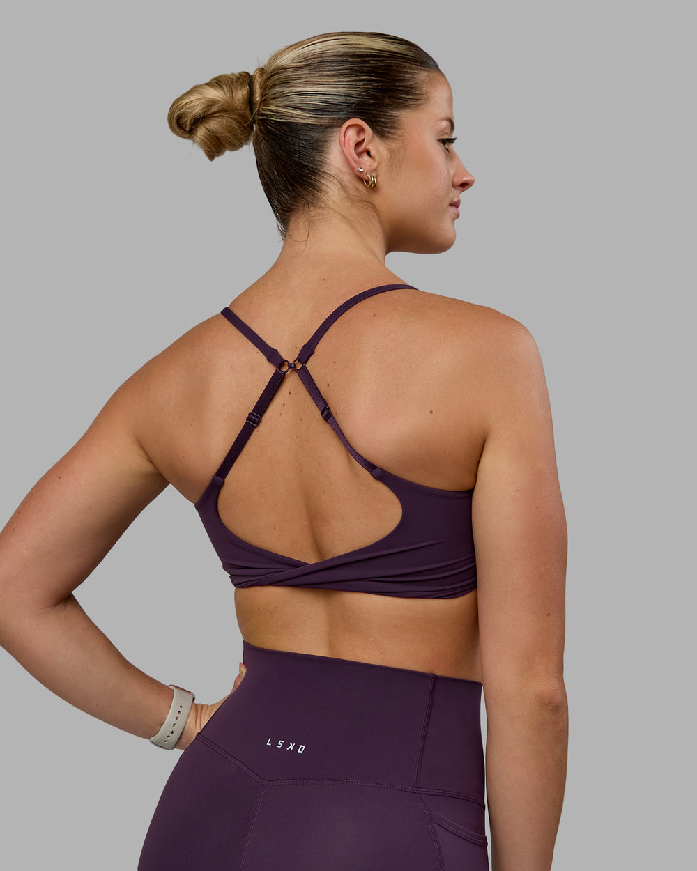 Woman wearing Twist Sports Bra - Midnight Plum