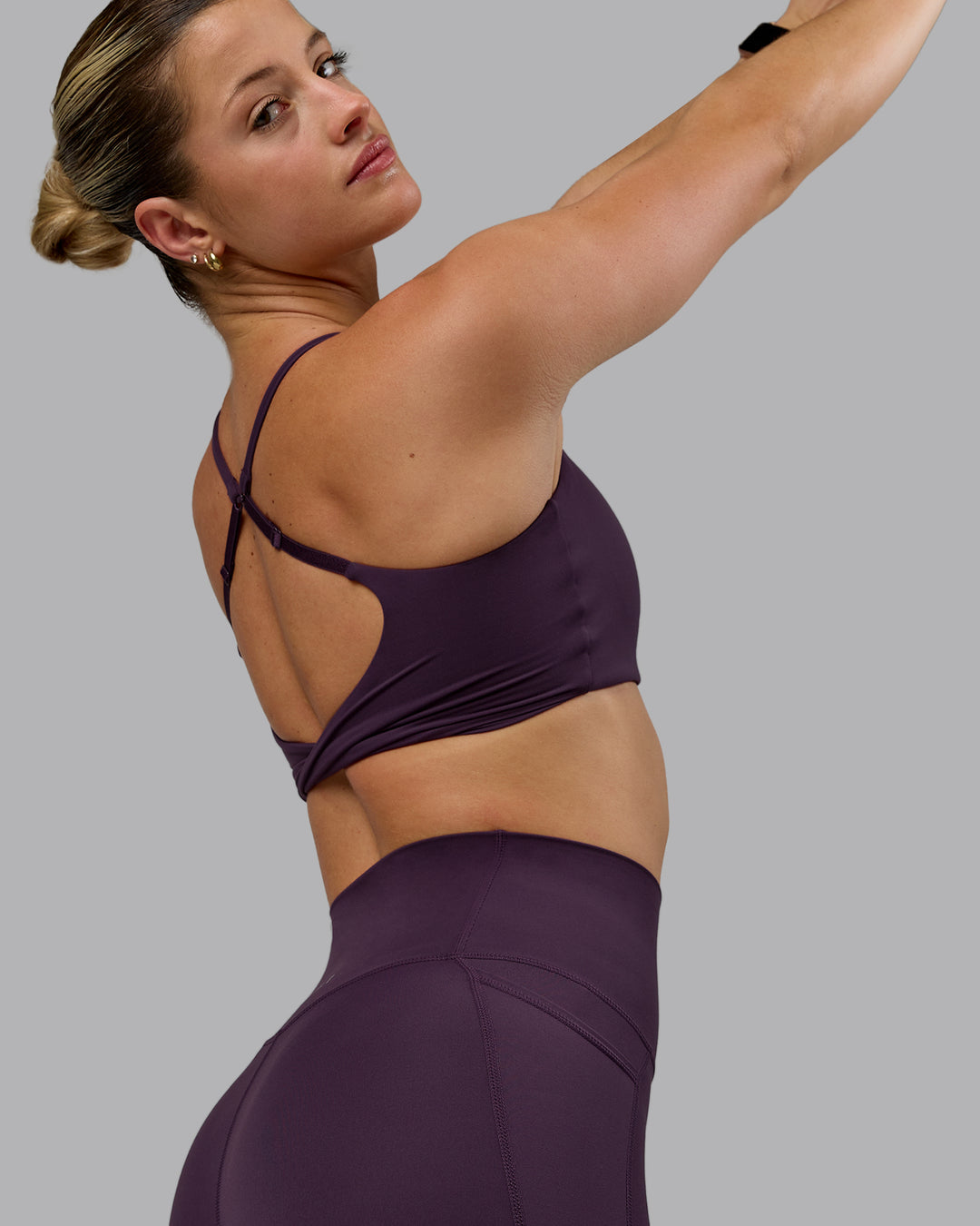 Woman wearing Twist Sports Bra - Midnight Plum