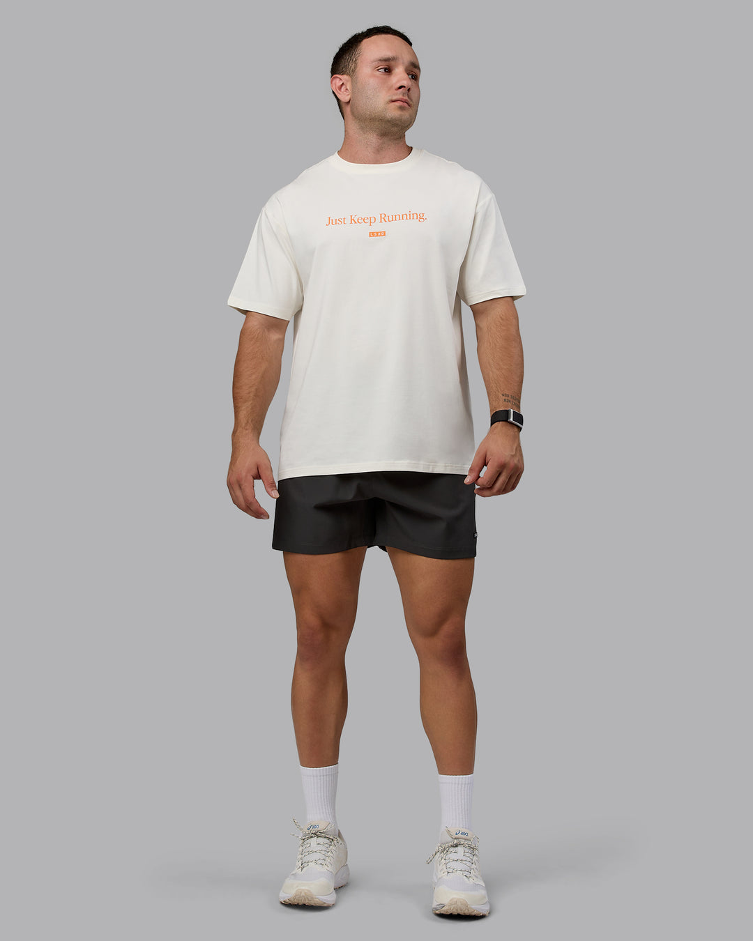 Man wearing Unisex Just Keep Running FLXCotton Tee Oversize - Off White-Vibrant Orange