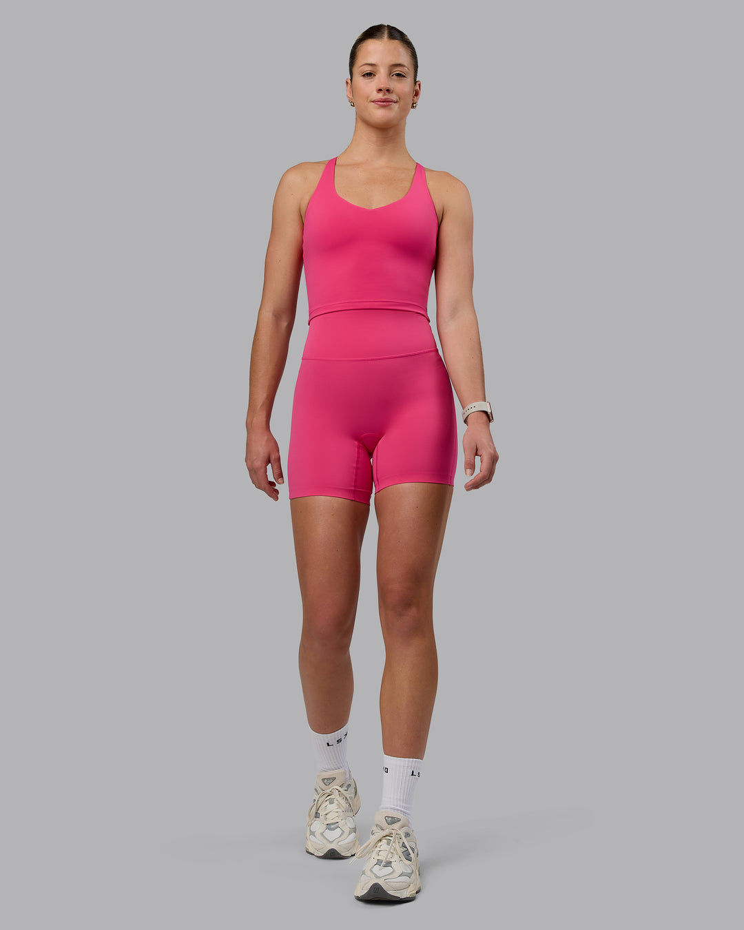 Woman wearing Elixir Mid Short Tights - Pink Flash