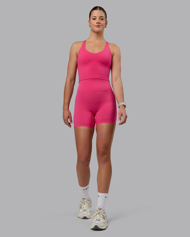 Woman wearing Elixir Mid Short Tights - Pink Flash
