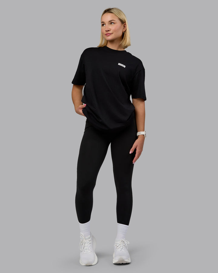 Woman wearing Fitstop Embrace the Sweat FLXCotton Oversized Tee in Black-White | Size:XS
