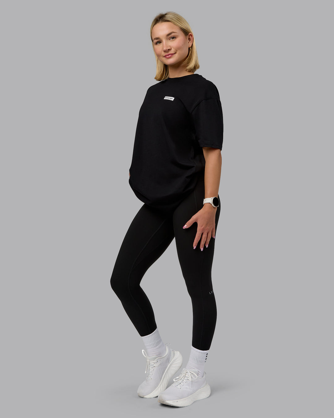 Woman wearing Fitstop Embrace the Sweat FLXCotton Oversized Tee in Black-White | Size:XS