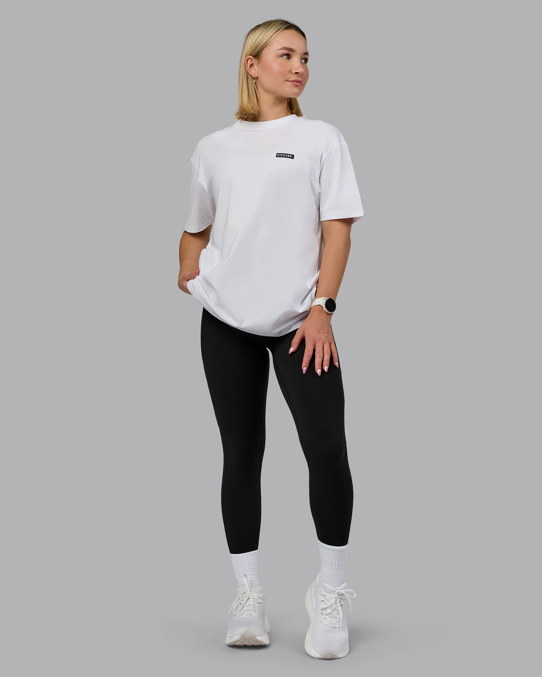 Woman wearing Fitstop Embrace the Sweat FLXCotton Oversized Tee in White-Black | Size:XS