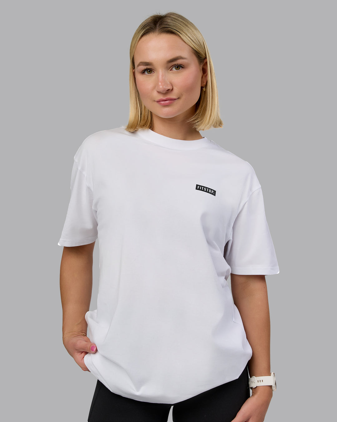 Woman wearing Fitstop Embrace the Sweat FLXCotton Oversized Tee in White-Black | Size:XS