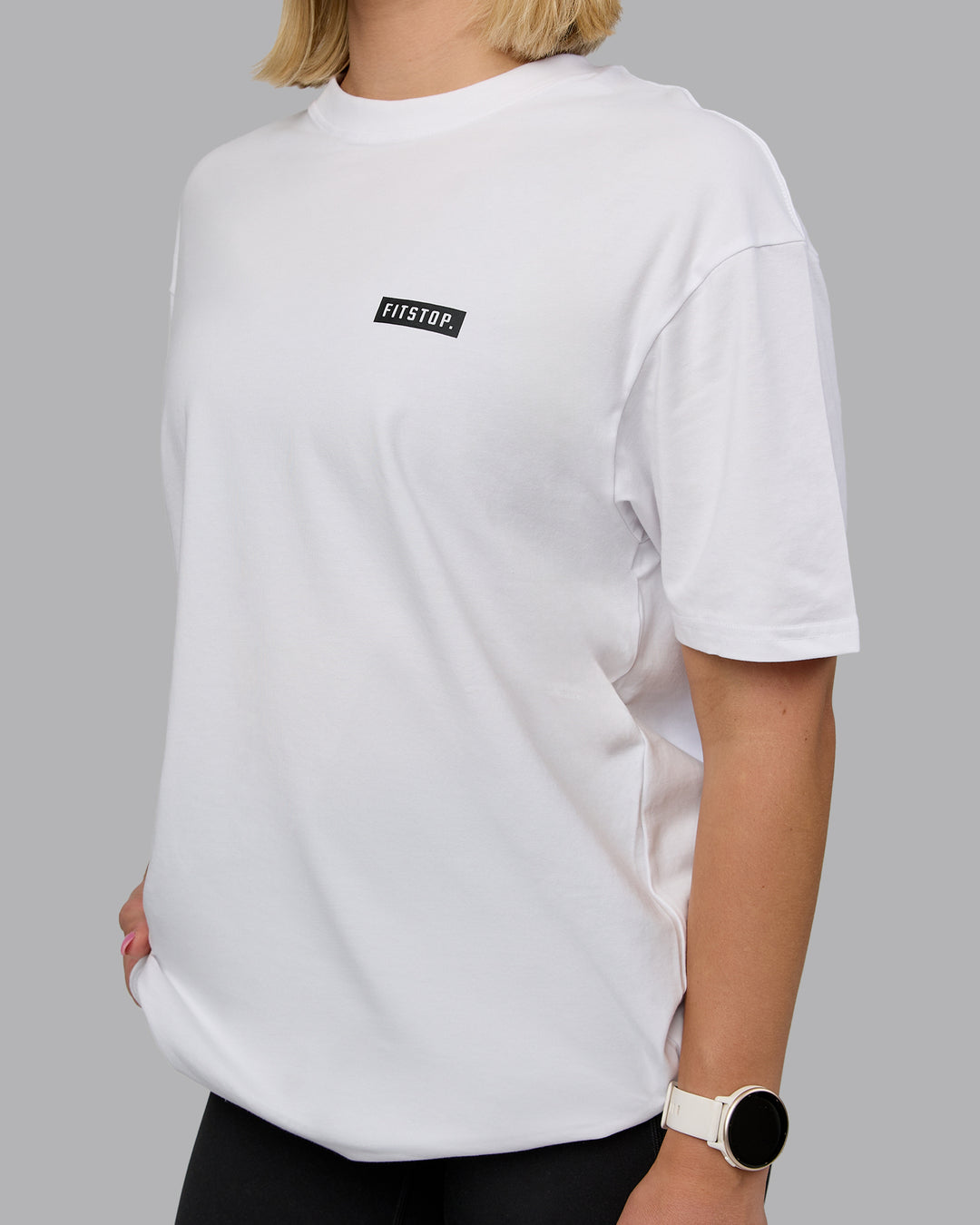 Woman wearing Fitstop Embrace the Sweat FLXCotton Oversized Tee in White-Black | Size:XS